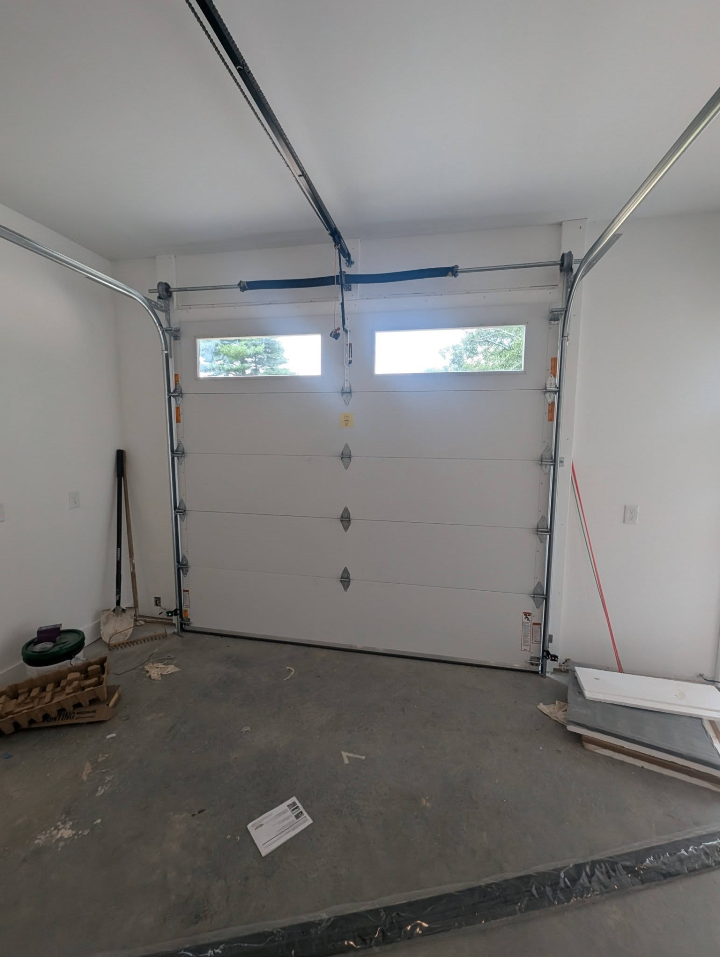 New white insulated garage door installed with windows