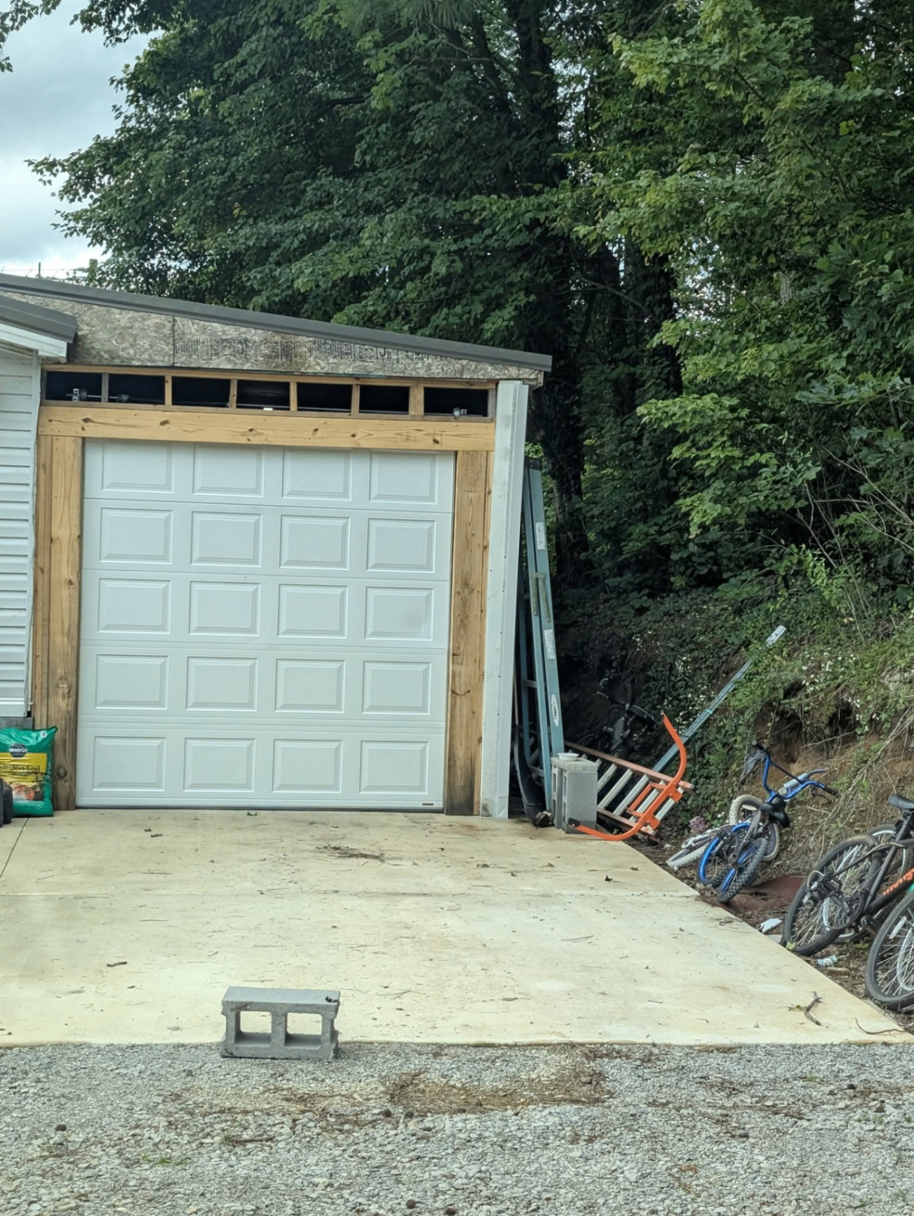 New white raised-panel garage door on detached garage